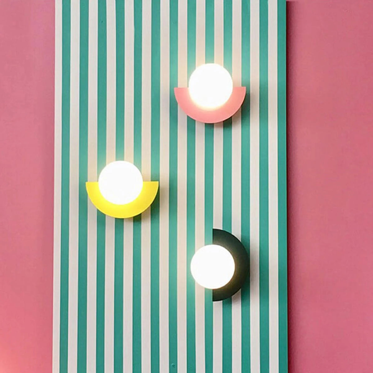 Three colorful wall lights on a striped background