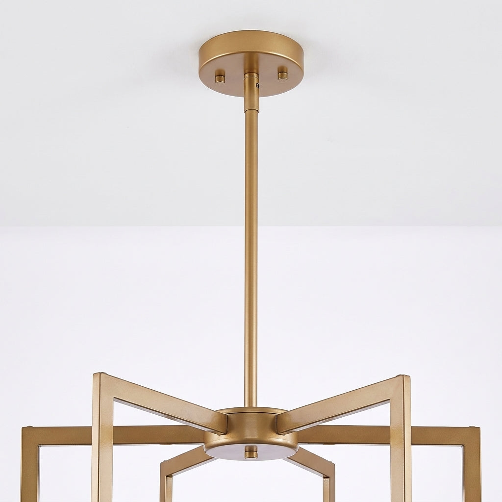 A modern geometric ceiling light fixture in a brushed gold finish, suspended from a circular ceiling canopy against a white wall.