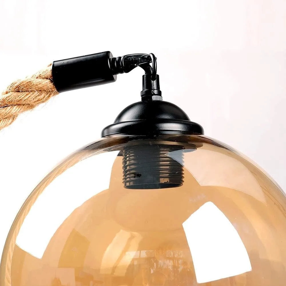 Vintage-style pendant light with glass shade and black fixture on a white background
