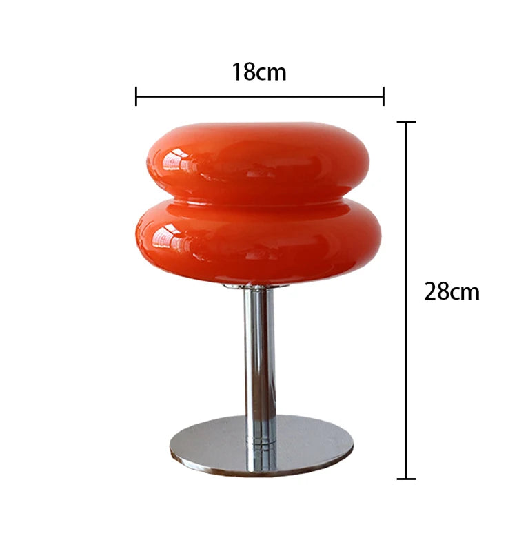 Orange lamp with a chrome base on a white background